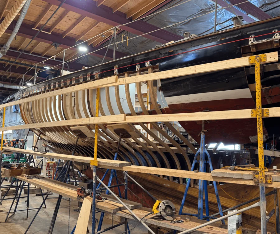 Glide's hull opened up in the shop, ribs and frames exposed the full length of the boat.